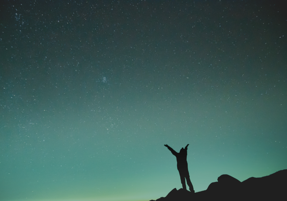 Gesture of gratitude against a night sky